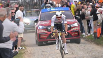 Alpecin - Deceuninck team's Dutch rider Mathieu Van Der Poel cycles in a lone breakaway ahead of the pack of riders on a cobblestone sector during the 121st edition of the Paris-Roubaix one-day classic cycling race, 260km between Compiegne and Roubaix, northern France, on April 7, 2024. 
Bernard PAPON / POOL / AFP