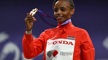 Gold medallist Kenya's athlete Beatrice Chebet celebrates on the podium for the women's 5000m final during the World Athletics Championships in Tokyo on September 21, 2025. 
Philip FONG / AFP