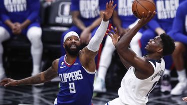 epa10496384 Minnesota Timberwolves guard Anthony Edwards (R) drives to the basket while being guarded by LA Clippers forward Marcus Morris Sr. (L) during the third quarter of the NBA basketball game between the Los Angeles Clippers and the Minnesota Timberwolves at Crypto.com Arena in Los Angeles, California, USA, 28 February 2023.  EPA/CAROLINE BREHMAN  SHUTTERSTOCK OUT