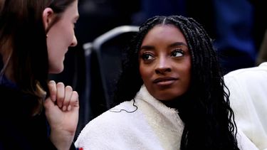 epa12755852 US gymnast Simone Biles (R) attends the Men's Ice Hockey quarterfinal match between USA and Sweden at the Milano Cortina 2026 Winter Olympic Games in Milano, Italy, 18 February 2026.  EPA/NEIL HALL
