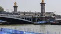 This photograph shows infrastructure on the venue of the swimming portion of the Paris 2024 Olympic Games triathlon, next to the Alexandre III bridge, on July 30, 2024. The Paris Olympics men's triathlon was postponed just hours before it was due to get under way on July 30 after water quality tests on the River Seine revealed it was still too dirty for swimming, organisers said.
Thibaud MORITZ / AFP