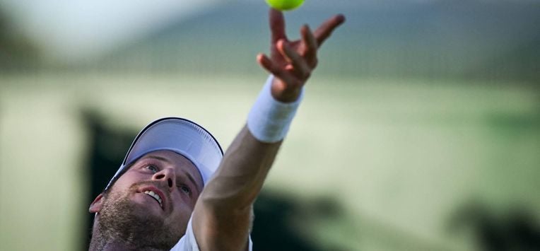 Netherlands' Botic Van De Zandschulp serves the ball to Italy's Matteo Arnaldi during their men's singles first round tennis match on the first day of the 2025 Wimbledon Championships at The All England Lawn Tennis and Croquet Club in Wimbledon, southwest London, on June 30, 2025. 
Kirill KUDRYAVTSEV / AFP