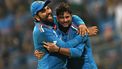 2023-11-15 17:39:47 India's Kuldeep Yadav (R) celebrates with his team captain Rohit Sharma after taking the wicket of New Zealand's Mark Chapman during the 2023 ICC Men's Cricket World Cup one-day international (ODI) first semi-final match between India and New Zealand at the Wankhede Stadium in Mumbai on November 15, 2023. 
Punit PARANJPE / AFP