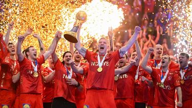 Denmark's players celebrate with the trophy on the podium after winning the final match of the IHF Men's Handball World Championship between Croatia and Denmark in Oslo, Norway on February 2, 2025. 
Jonathan NACKSTRAND / AFP