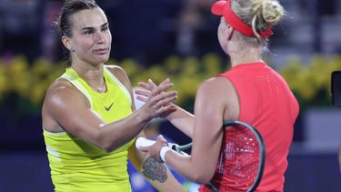 epa11907704 Clara Tauson (R) of Denmark celebrates winning her third round match against Aryna Sabalenka (L) of Belarus at the Dubai Duty Free Tennis WTA Championships 2025 in Dubai, United Arab Emirates, 19 February 2025.  EPA/ALI HAIDER