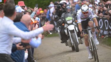 Alpecin - Deceuninck team's Dutch rider Mathieu Van Der Poel cycles in a lone breakaway ahead of the pack of riders on a cobblestone sector during the 121st edition of the Paris-Roubaix one-day classic cycling race, 260km between Compiegne and Roubaix, northern France, on April 7, 2024. 
Bernard PAPON / POOL / AFP