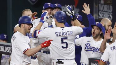 2023-10-27 22:27:54 epa10944087 Texas Rangers Corey Seager (C) is greeted by teammates after hitting a home run during the ninth inning of game one of the Major League Baseball (MLB) World Series between the Texas Rangers and the Arizona Diamondbacks at Globe Life Field in Arlington, Texas, USA, 27 October 2023. The World Series is the best-of-seven games.  EPA/JOHN G. MABANGLO