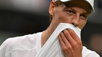 Italy's Jannik Sinner wipes his face with his shirt as he plays against Serbia's Miomir Kecmanovic during their men's singles tennis match on the fifth day of the 2024 Wimbledon Championships at The All England Lawn Tennis and Croquet Club in Wimbledon, southwest London, on July 5, 2024. 
Glyn KIRK / AFP