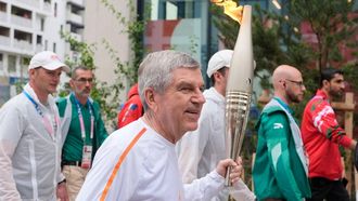 International Olympic Committee (IOC) President Thomas Bach takes part in the Olympic village torch relay in the Olympic Village in Paris on July 26, 2024, ahead of the Paris 2024 Olympic Games.  
David Goldman / POOL / AFP