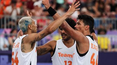 (From L) Netherlands' #54 Worthy de Jong, Netherlands' #13 Dimeo van der Horst and Netherlands' #44 Arvin Slagter celebrate after winning the men's pool round 3x3 basketball game between the Netherlands and Lithuania during the Paris 2024 Olympic Games at La Concorde in Paris on August 2, 2024. 
David GRAY / AFP