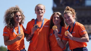 Members of team Netherlands, women's field hockey gold medallists, celebrate on stage at the Champions Park at Trocadero during the Paris 2024 Olympic Games in Paris on August 10, 2024, with the Eiffel Tower visible in the background. 
Dimitar DILKOFF / AFP