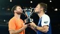 epaselect epa12693865 Christian Harrison (L) of the USA and Neal Skupski (R) of Great Britian pose with the winners trophy after winning the men’s doubles final against Jason Kubler and Marc Polmans  of Australia on day 14 of the 2026 Australian Open tennis tournament at Melbourne Park in Melbourne, Australia, 31 January 2026.  EPA/JOEL CARRETT AUSTRALIA AND NEW ZEALAND OUT