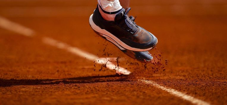 A photo shows the shoes of France's Leolia Jeanjean as she hits a return in her women's singles match against Hungary’s Amarissa Kiara Toth during the Billie Jean King Cup play-offs between France and Hungary, at Oeiras outskirts of Lisbon, on April 10, 2026. 
FILIPE AMORIM / AFP