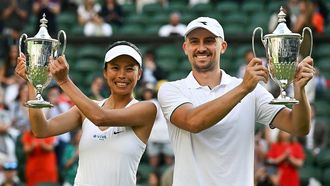 Taiwan's Hsieh Su-wei (L) and Poland's Jan Zielinski (R) celebrate with their trophies following their victory against  Mexico's Santiago Gonzalez and Mexico's Giuliana Olmos in their mixed doubles final tennis match on the fourteenth day of the 2024 Wimbledon Championships at The All England Lawn Tennis and Croquet Club in Wimbledon, southwest London, on July 14, 2024. 
Ben Stansall / AFP