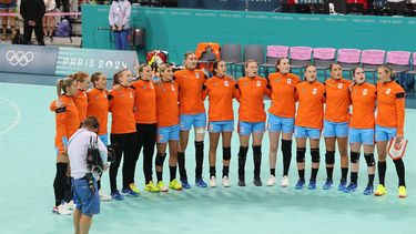 Netherlands' players listen to national anthems before the women's quarter-final handball match between Denmark and The Netherlands of the Paris 2024 Olympic Games, at the Pierre-Mauroy stadium in Villeneuve-d'Ascq, northern France, on August 6, 2024. 
Francois LO PRESTI / AFP