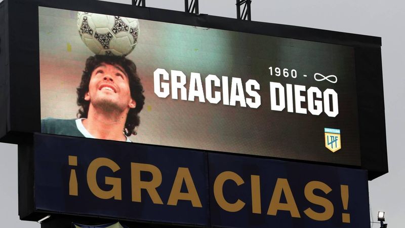 epa08852132 The stadium's screen displays a image of Diego Maradona and the legend '1960-infinity Thanks Diego' as part of a tribute to the late football legend during a match between Boca Juniors and Newell's Old Boys for the 2020 Argentine Primera Division, at La Bombonera stadium, in Buenos Aires, 29 November 2020. The Argentine football championship has been renamed to honour the late Diego Maradona.  EPA/ALEJANDRO PAGNI / POOL