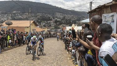 Residents gather to look at cyclists competing during the final stage of the 16h Tour du Rwanda on 25 february 2024, in Kigali. Israel Premier Tech’s British rider Joseph Blackmore, won the Tour of Rwanda which ended on Sunday in the capital Kigali. 
Guillem Sartorio / AFP