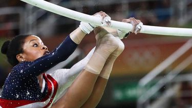 epa05468728 Gabrielle Douglas of the USA competes on the Uneven Bars during the Women's Team Final of the Rio 2016 Olympic Games Artistic Gymnastics events at the Rio Olympic Arena in Barra da Tijuca, Rio de Janeiro, Brazil, 09 August 2016.  EPA/HOW HWEE YOUNG