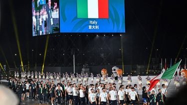 Members of Italy's delegation wave their country's national flag as they take part in the athletes' parade during the opening ceremony of the 2025 World Games at the Tianfu International Convention Centre in Chengdu, in China's southwestern Sichuan province on August 7, 2025. Italian orienteering athlete Mattia Debertolis died on August 12, 2025, at the World Games in Chengdu, after collapsing during competition, organisers said.
JADE GAO / AFP