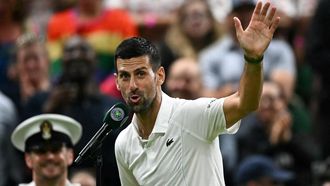 Winner Serbia's Novak Djokovic speaks during an interview and reacts to the cheering of the crowd at the end of his men's singles tennis match against Denmark's Holger Rune on the eighth day of the 2024 Wimbledon Championships at The All England Lawn Tennis and Croquet Club in Wimbledon, southwest London, on July 8, 2024. 
Ben Stansall / AFP