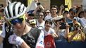 Spectators cheer and take photographs as UAE Team Emirates team's Slovenian rider Tadej Pogacar (L) adjusts his ear-piece at the start of the 1st stage of the 111th edition of the Tour de France cycling race, 206 km between Florence and Rimini, in Italy, on June 29, 2024. 
Marco BERTORELLO / AFP