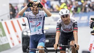 epa12071235 Lenny Martinez (L) from France of team Bahrain Victorius celebrates winning, past Joao Almeida from Portugal of UAE Team Emirates XRG, the fourth stage, a 118,2 km race between Sion and Thyon 2000 at the 78th Tour de Romandie UCI World Tour Cycling race, in Thyon, Switzerland, 03 May 2025.  EPA/JEAN-CHRISTOPHE BOTT