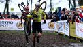 Belgium's Wout van Aert (front) carries his bike as he competes in the men's elite Superprestige cyclocross cycling race, in Gullegem on January 4, 2025. 
DAVID PINTENS / Belga / AFP