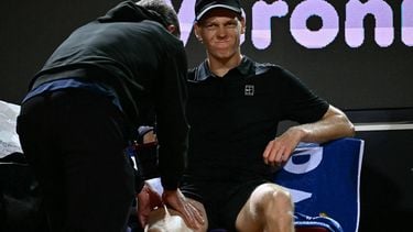 Italy's Jannik Sinner grimaces as he receives a massage during a break in the semi-final match against  Russia's Daniil Medvedev at the ATP Rome Open tennis tournament at Foro Italico in Rome on May 15, 2026.  
Filippo MONTEFORTE / AFP