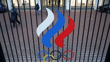 epa10978635 A woman walks next to the symbol of the Russian Olympic Committee after a Russian sports officials meeting dedicated to the 100th anniversary of Dynamo Sports Club at the Russian Olympic Committee (ROC) headquarters in Moscow, Russia 16 November 2023. The club was founded as sports and fitness club in 1923.  EPA/MAXIM SHIPENKOV