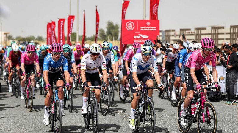 Riders launch from the start line during the first stage of the UAE Tour cycling event from Madinat Zayed Majlis to Liwa Palace in Abu Dhabi on February 16, 2026. 
Fadel SENNA / AFP