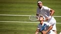 Australia's Rinky Hijikata (front) playing with Netherlands' David Pel (rear) eyes the ball as they return it to Britain's Julian Cash and Britain's Lloyd Glasspool during their men's doubles final tennis match on the thirteenth day of the 2025 Wimbledon Championships at The All England Lawn Tennis and Croquet Club in Wimbledon, southwest London, on July 12, 2025. 
HENRY NICHOLLS / AFP