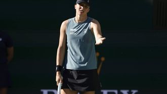 epa12815933 Iga Swiatek of Poland reacts after losing a point during the women's singles quarterfinals match against Elina Svitolina of Ukraine on day 9 of the BNP Paribas Open tennis tournament in Indian Wells, California, USA, 12 March 2026.  EPA/JOHN G. MABANGLO