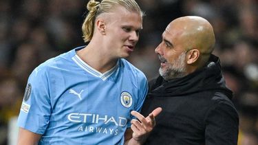 Manchester City's Norwegian forward #09 Erling Haaland (L) speaks with Manchester City's Spanish head coach Pep Guardiola during the UEFA Champions League Group G football match between Young Boys (SUI) and Manchester City (ENG) at The Wankdorf Stadium, in Bern on October 25, 2023. 
Fabrice COFFRINI / AFP