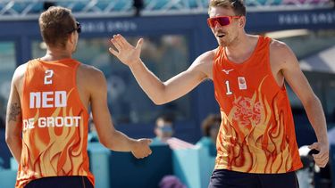 Netherlands' #01 Stefan Boermans and Netherlands' #02 Yorick De Groot celebrate a point in the men's pool F beach volleyball match between Netherlands and Spain during the Paris 2024 Olympic Games at the Eiffel Tower Stadium in Paris on July 29, 2024. 
Luis TATO / AFP