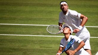 Australia's Rinky Hijikata (front) playing with Netherlands' David Pel (rear) eyes the ball as they return it to Britain's Julian Cash and Britain's Lloyd Glasspool during their men's doubles final tennis match on the thirteenth day of the 2025 Wimbledon Championships at The All England Lawn Tennis and Croquet Club in Wimbledon, southwest London, on July 12, 2025. 
HENRY NICHOLLS / AFP