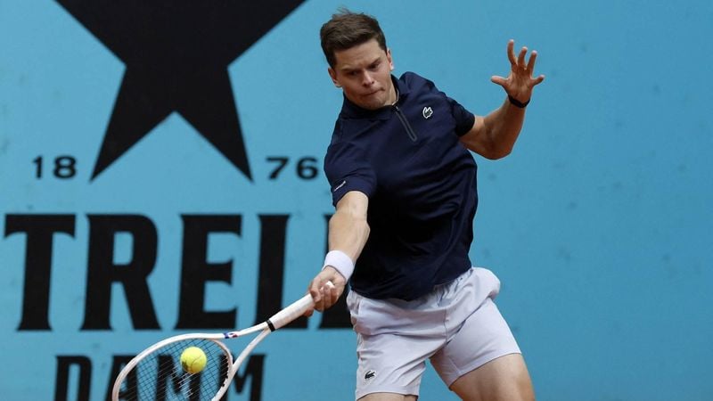 Belgium's Alexander Blockx returns the ball to Canada's Felix Auger-Aliassime during their 2026 ATP Tour Madrid Open tennis tournament third round singles match at the Caja Magica in Madrid, on April 27, 2026.  
OSCAR DEL POZO / AFP