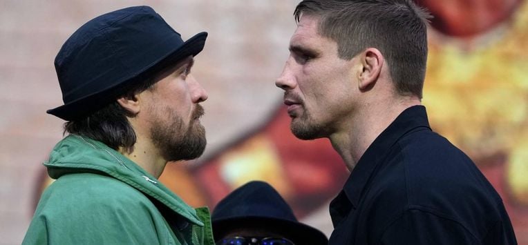 Ukraine's Oleksandr Usyk faces off with Netherlands' Rico Verhoeven (R) during a press conference, in east London on April 14, 2026, ahead of their WBC World Heavyweight Championship 'Glory in Giza' boxing match, taking place on May 23, 2026 in Egypt. 
CARLOS JASSO / AFP