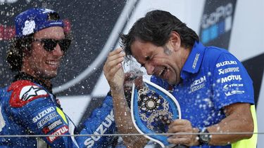 Suzuki Ecstar's Spanish rider Alex Rins (L) sprays champagne over Suzuki team manager Davide Brivio (R) on the podium as he celebrates his victory in the Moto GP race of the British Grand Prix at Silverstone circuit in Northamptonshire, central England, on August 25, 2019. Alex Rins won the British MotoGP in dramatic fashion as the Team Suzuki rider pipped world champion Marc Marquez to the finish line by 0.013 seconds at Silverstone on Sunday.
Adrian DENNIS / AFP
