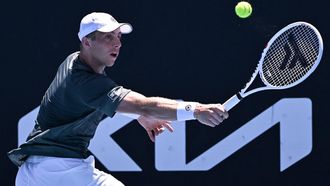 Netherlands' Tallon Griekspoor hits a return against Russia's Roman Safiullin during their men's singles match on day three of the Australian Open tennis tournament in Melbourne on January 16, 2024. 
WILLIAM WEST / AFP