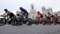 Overall leader Team Jumbo-Visma's US rider Sepp Kuss (R) rides in front of the Palace of Post and Telecommunications during the 21st and last stage of the 2023 La Vuelta cycling tour of Spain, a 101,1 km race between the hippodrome of La Zarzuela and Madrid, on September 17, 2023. 
Oscar DEL POZO / AFP