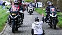 A protestor sits on the road while riders compete in the 'Ronde van Brugge' men's elite one-day cycling race, 202,9 km from and to Bruges on March 25, 2026. 
MAARTEN STRAETEMANS / Belga / AFP