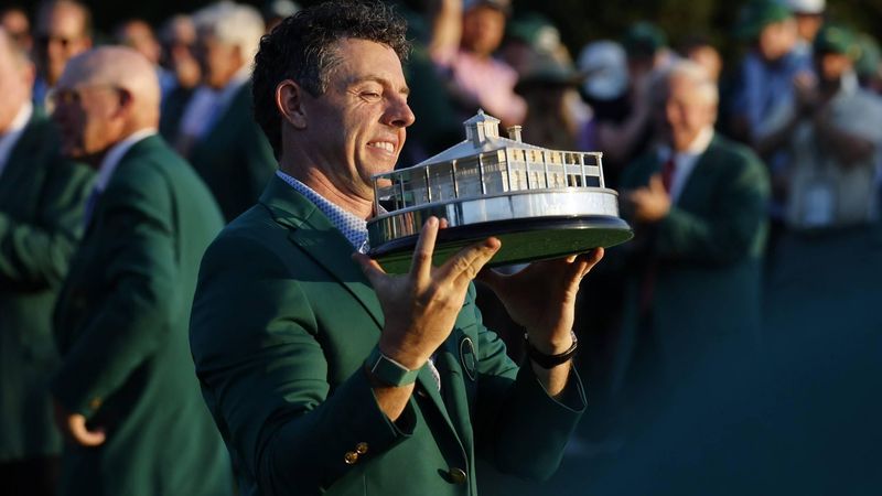 epa12886301 2026 Masters tournament champion Rory McIlroy of Northern Ireland holds up the trophy while wearing the Green Jacket after winning the final round of the 2026 Masters tournament in Augusta, Georgia, USA, 12 April 2026.  EPA/ERIK S. LESSER