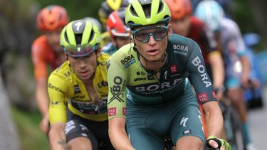 Team Bora's Russian rider Aleksandr Vlasov (R) cycles ahead of Team Bora's Slovenian rider Primoz Roglic wearing the overall leader's yellow jersey during the seventh stage of the 76th edition of the Criterium du Dauphine cycling race, 155,3km between Albertville and Samoens 1600, French Alps, on June 8, 2024. 
Thomas SAMSON / AFP