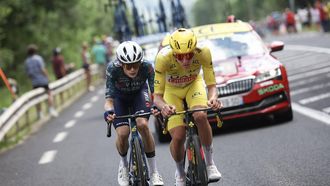 UAE Team Emirates team's Slovenian rider Tadej Pogacar wearing the overall leader's yellow jersey and Team Visma - Lease a Bike team's Danish rider Jonas Vingegaard cycle in the final kilometers of the 11th stage of the 111th edition of the Tour de France cycling race, 211 km between Évaux-les-Bains and Le Lioran, in the Massif Central mountains of central France, on July 10, 2024. 
Anne-Christine POUJOULAT / AFP