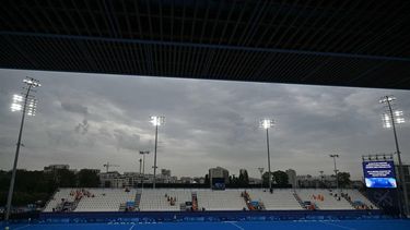 Fans and players leave the pitch after weather conditions forced the suspension of the session after the men's pool A field hockey match between Germany and the Netherlands during the Paris 2024 Olympic Games at the Yves-du-Manoir Stadium in Colombes on July 31, 2024. 
Mauro PIMENTEL / AFP