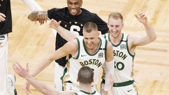 epa11140940 Boston Celtics guard Payton Pritchard is greeted by teammates Kristaps Porzingis (C) and Sam Hauser (R) during the second half of an NBA game between the Boston Celtics and the Washington Wizards in Boston, Massachusetts, USA, 09 February 2024.  EPA/CJ GUNTHER SHUTTERSTOCK OUT