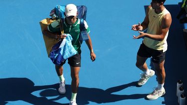 Spain's Carlos Alcaraz (R) applauds China's Shang Juncheng as he retires from their men's singles match on day seven of the Australian Open tennis tournament in Melbourne on January 20, 2024. 
Martin KEEP / AFP