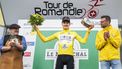epa11304816 Carlos Rodriguez from Spain of team Ineos Grenadiers celebrates on the podium wearing the overall leader's yelow jersey after the fourth stage, a 151.7 km race between Saillon and Leysin at the 77th Tour de Romandie UCI World Tour Cycling race, Leysin, Switzerland, 27 April 2024.  EPA/JEAN-CHRISTOPHE BOTT