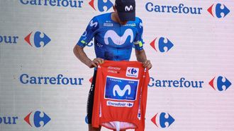 New overall race leader Team Movistar's Spanish rider Enric Mas holds the race leader's red jerse without wearing it on the podium after the eighth stage of the Vuelta a Espana 2026, a 171 km race between Pucol and Xeraco on August 29, 2026.   Previous race leader Tadej Pogacar pulled out of the Vuelta a Espana on Saturday after a heavy fall 31km from the finish of a flat stage eight left him with shoulder and face injuries. Pogacar of Team UAE has won five Tour de France titles and a Giro d'Italia and was targetig his first overall victory on the Spanish 21-day race.
Josep LAGO / AFP