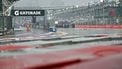 A track marshal looks on as he sweeps rain water off the track before the start of the sprint race ahead of the Formula One Singapore Grand Prix at the Marina Bay Street Circuit in Singapore on October 10, 2026. 
ANTHONY WALLACE / AFP
